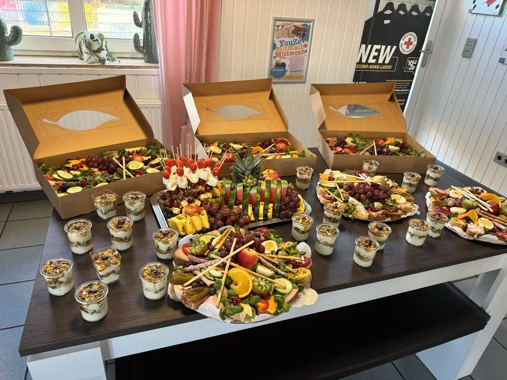 Cateringboxen, Platten und Dessertgläser auf einem Tisch